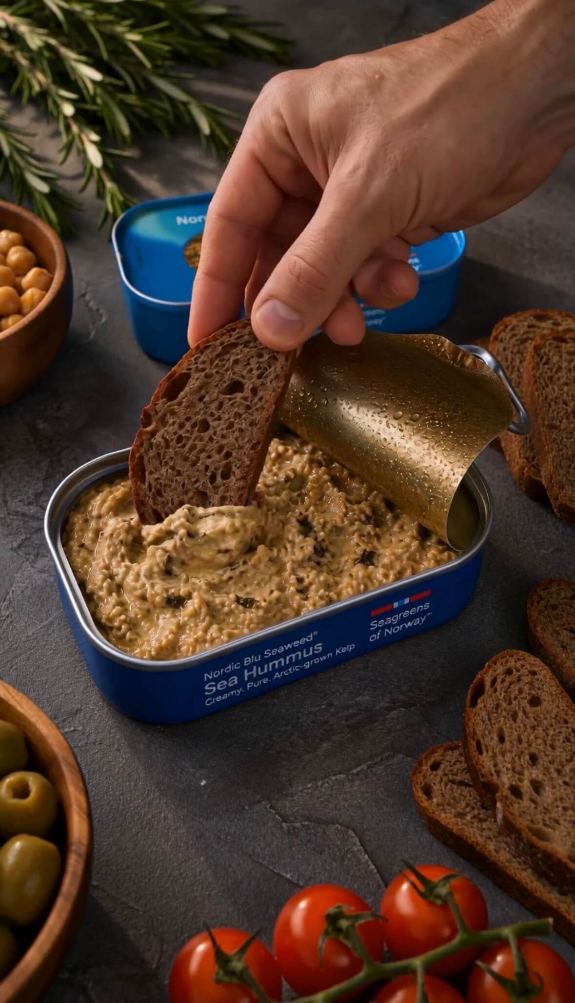 Rye bread dipped into an open can of Sea Hummus